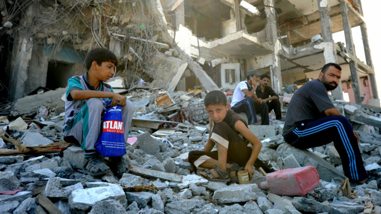 A Palestinians searches through rubble of his destroyed homes hit by Israeli strikes in Towers Al-andaa - the northern Gaza Strip